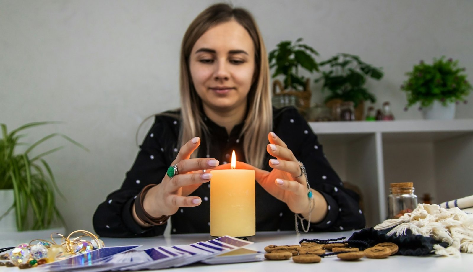 Woman fortune teller fortune telling on a candle. Selective focus.